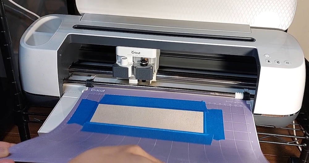 Step 4b: Feed your mat into the Cricut and press the arrow button Step 4b: I feed my mat into the Cricut.